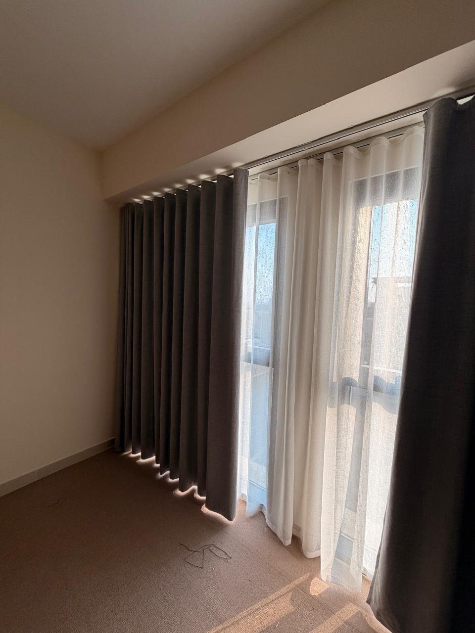 Umeema charcoal wave curtains and white sheers installed on double rails